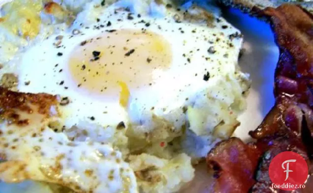 Ouă coapte pe un pat de cartofi cu slănină